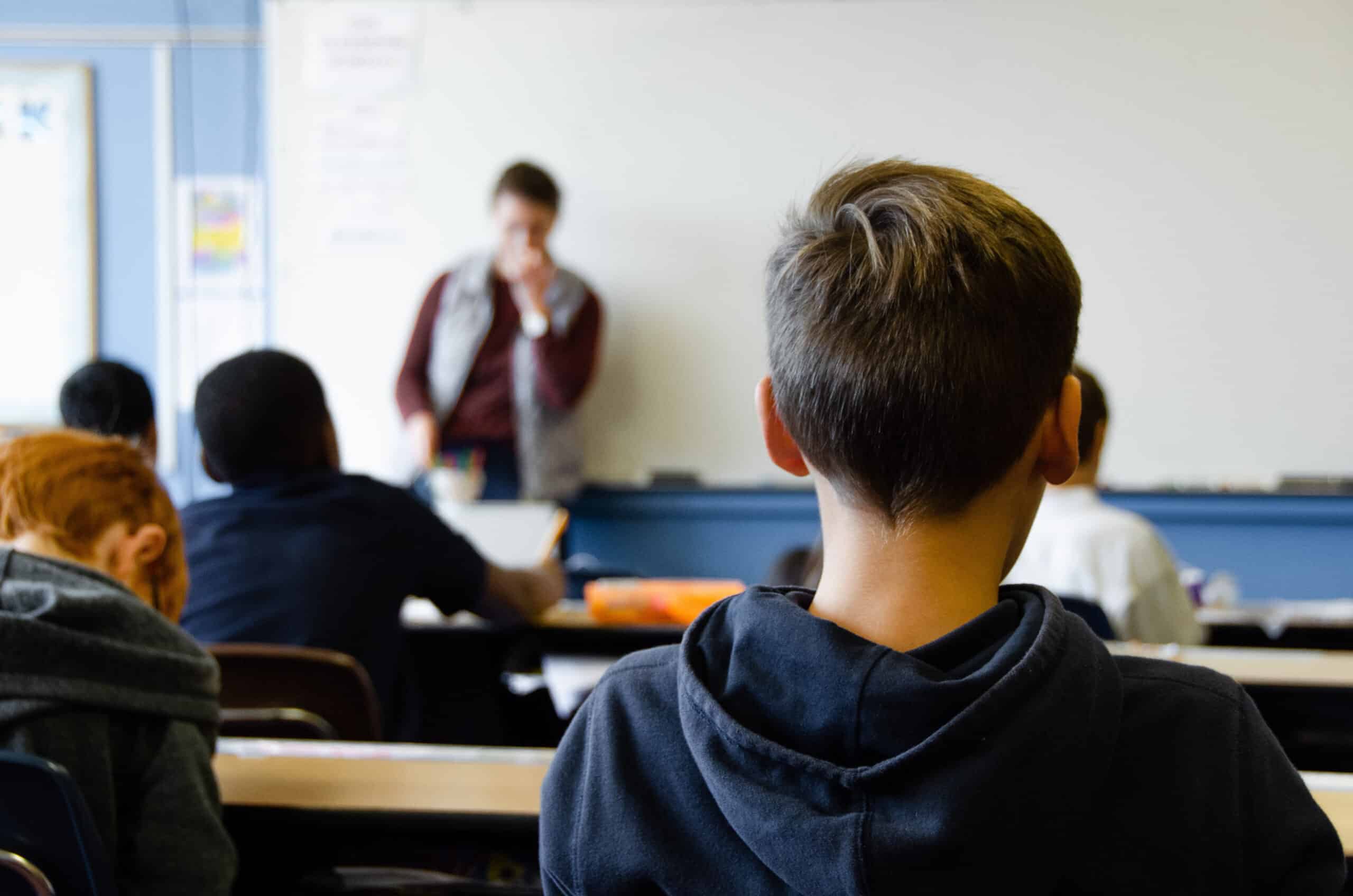 student sitting in class listening to teacher